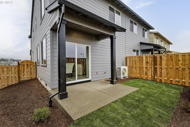 rear view of property featuring a patio, ac unit, and a lawn