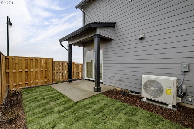 exterior space featuring a yard, a patio area, and ac unit