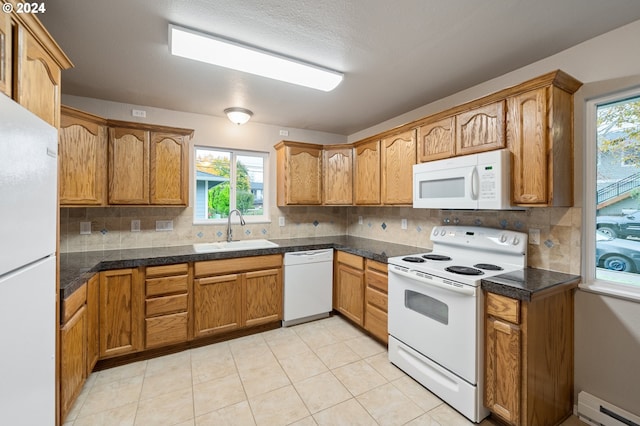 kitchen with plenty of natural light, sink, a baseboard radiator, and white appliances