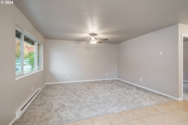 empty room with baseboard heating, light colored carpet, and ceiling fan