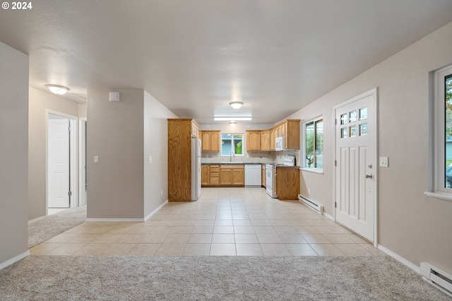 kitchen with light carpet, a baseboard heating unit, and white appliances