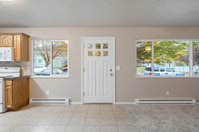 tiled entrance foyer featuring baseboard heating