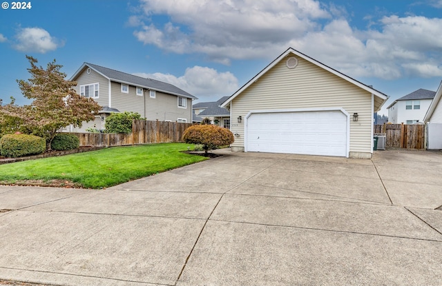 view of front of home featuring a garage and a front lawn