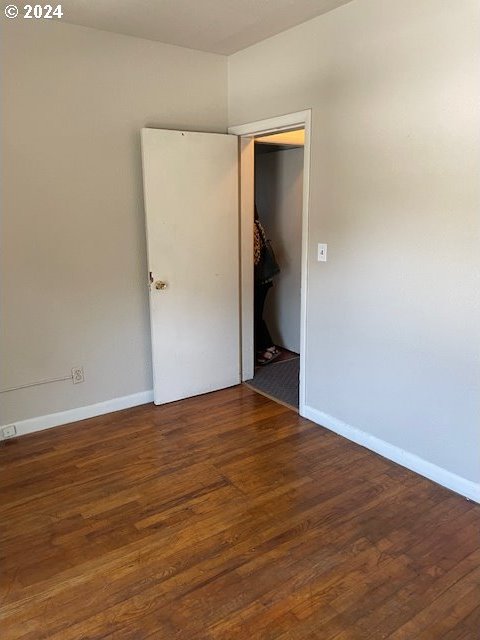 unfurnished room featuring dark hardwood / wood-style floors