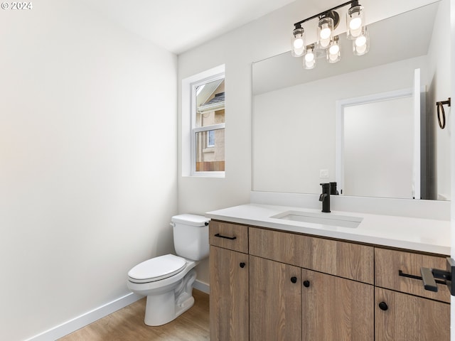 bathroom featuring hardwood / wood-style floors, toilet, and vanity