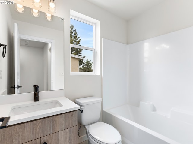 full bathroom featuring toilet, vanity, and  shower combination