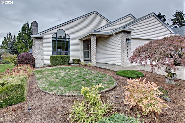 ranch-style house with a front yard and a garage