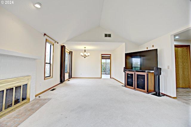 unfurnished living room featuring light carpet, a notable chandelier, a fireplace, and vaulted ceiling