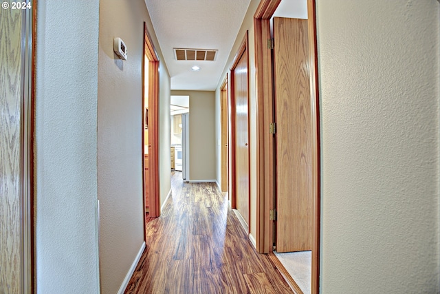 hallway with wood-type flooring