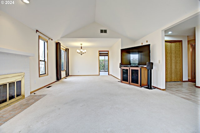 unfurnished living room featuring light carpet, lofted ceiling, a chandelier, and a fireplace