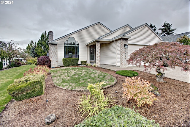 ranch-style house with a front yard and a garage