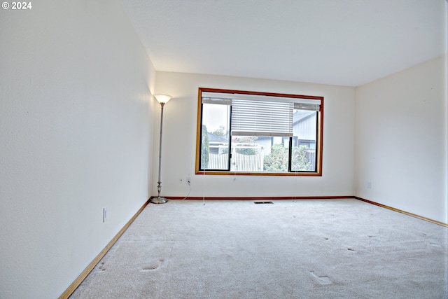 empty room with light colored carpet