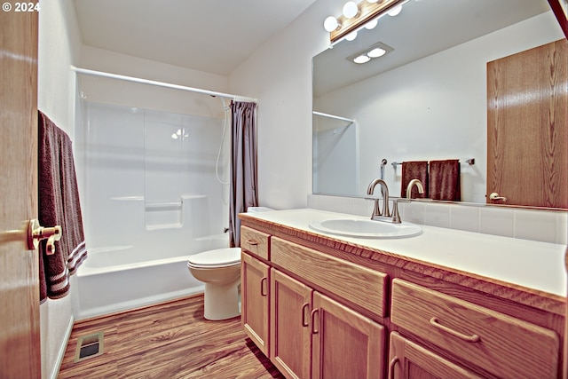 full bathroom with shower / tub combo with curtain, vanity, wood-type flooring, and toilet