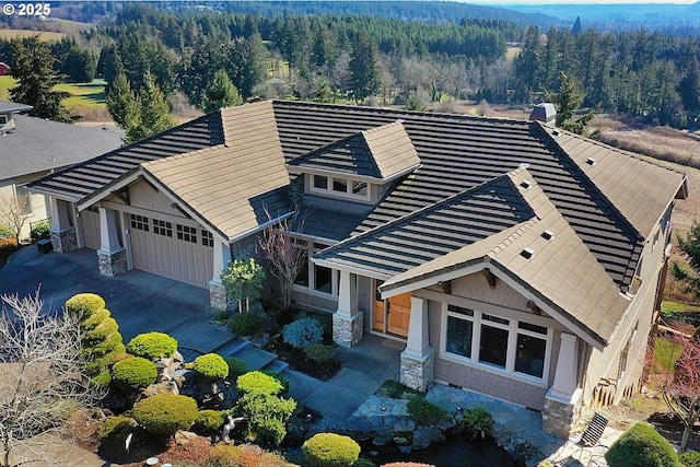 drone / aerial view featuring a wooded view