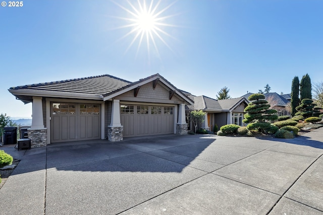 18262 Meadowlark Ln, Lake Oswego, OR 97034 - craftsman-style house with stone siding, driveway, an attached garage, and a tiled roof
