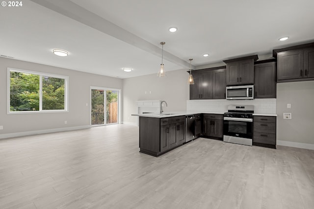 kitchen featuring tasteful backsplash, kitchen peninsula, light hardwood / wood-style flooring, stainless steel appliances, and decorative light fixtures