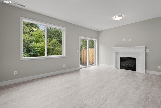 unfurnished living room featuring light hardwood / wood-style floors and a fireplace