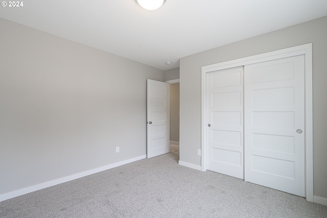 unfurnished bedroom with carpet floors and a closet