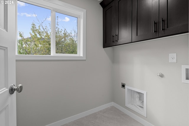 laundry area featuring hookup for a gas dryer, hookup for an electric dryer, and cabinets