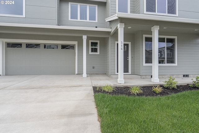 view of exterior entry featuring a garage