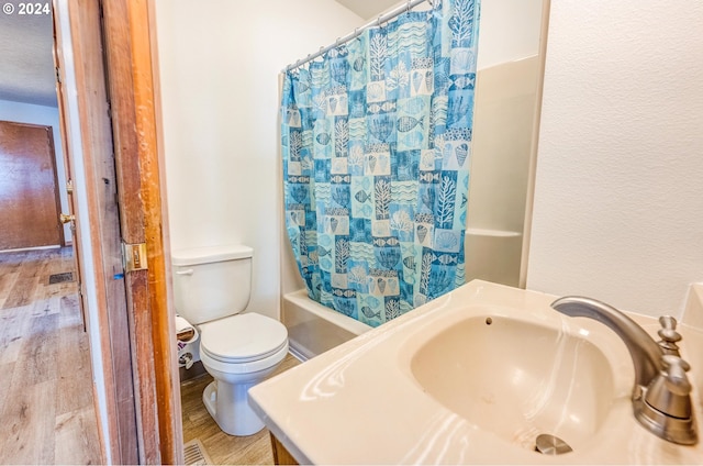 full bathroom with vanity, wood-type flooring, toilet, and shower / tub combo