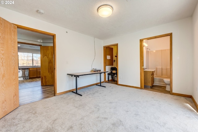 carpeted spare room featuring a textured ceiling