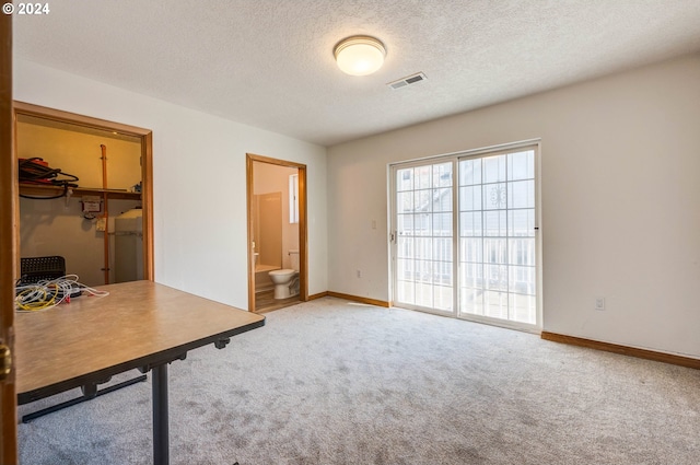 carpeted office space with a textured ceiling