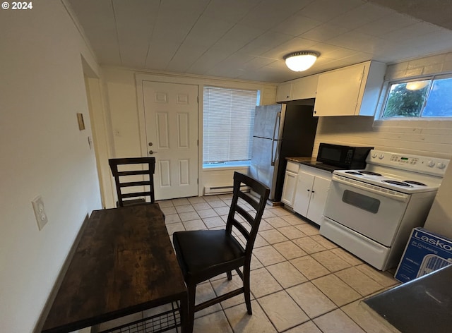 kitchen featuring white cabinets, electric range, light tile patterned floors, and stainless steel fridge