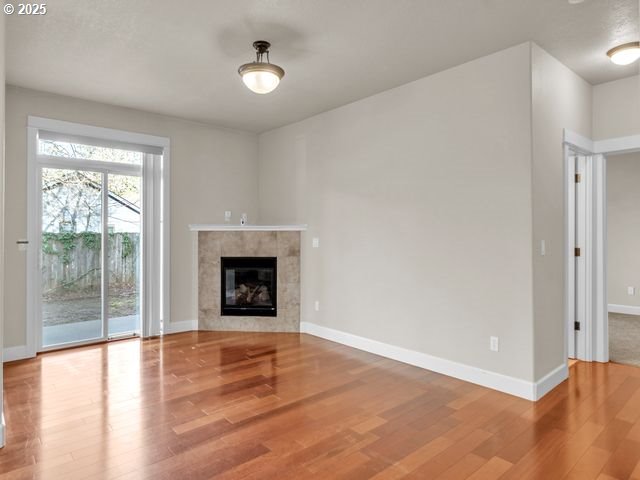 unfurnished living room featuring hardwood / wood-style floors and a fireplace