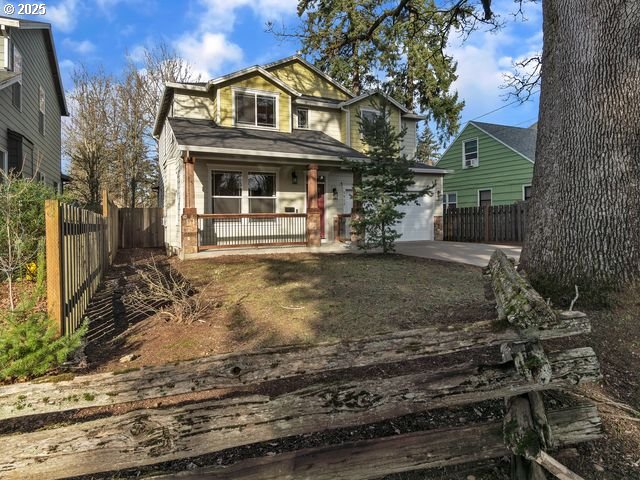 view of front facade with a garage and covered porch