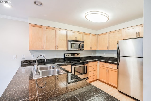 kitchen with sink, appliances with stainless steel finishes, light hardwood / wood-style flooring, and light brown cabinets