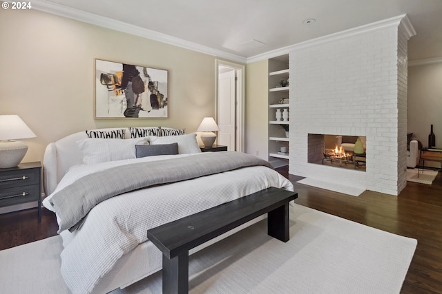 bedroom with a fireplace, crown molding, and dark wood-type flooring