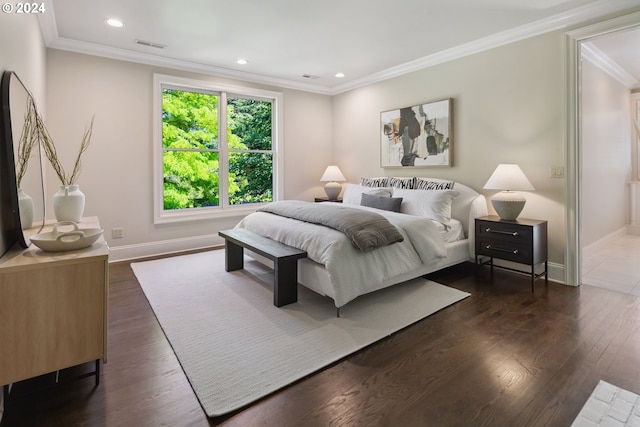 bedroom with dark hardwood / wood-style flooring and crown molding