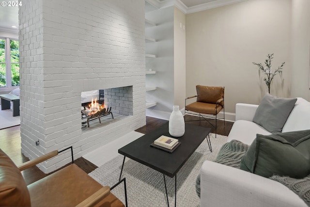 living room featuring a brick fireplace, hardwood / wood-style floors, and ornamental molding