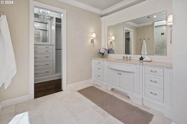 bathroom featuring tile patterned flooring, crown molding, and vanity