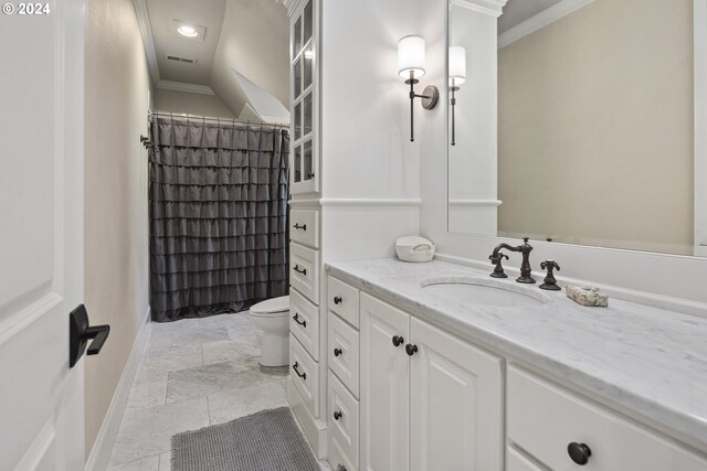 bathroom featuring vanity, crown molding, toilet, and tile patterned floors