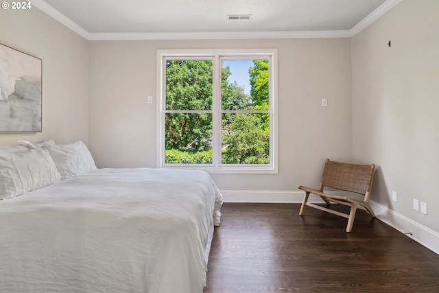 bedroom featuring multiple windows, crown molding, and hardwood / wood-style floors