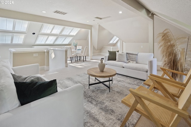 carpeted living room featuring a textured ceiling, lofted ceiling, and a wealth of natural light