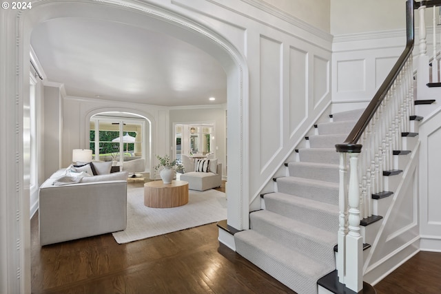 living room featuring crown molding and dark hardwood / wood-style floors