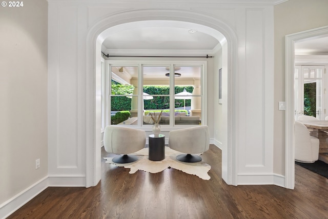 interior space featuring ornamental molding, plenty of natural light, and dark wood-type flooring