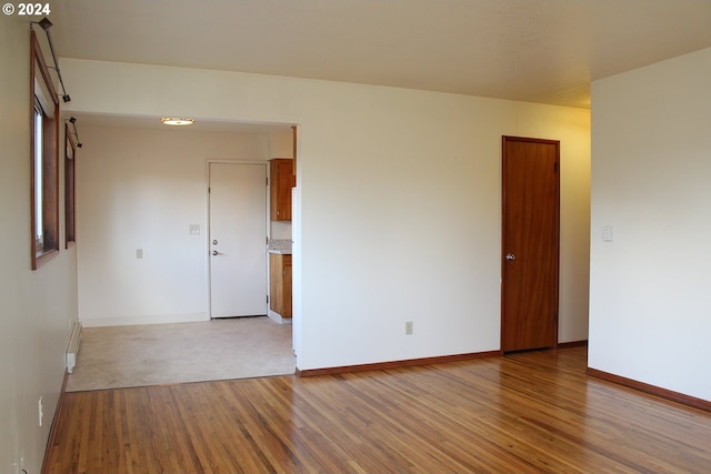 spare room with light hardwood / wood-style flooring