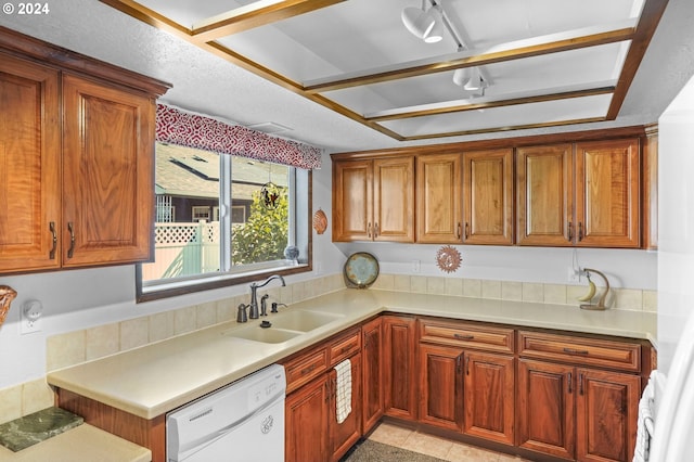 kitchen featuring dishwasher, light tile patterned floors, and sink