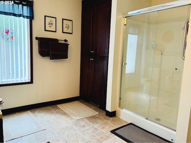 bathroom with a shower with shower door