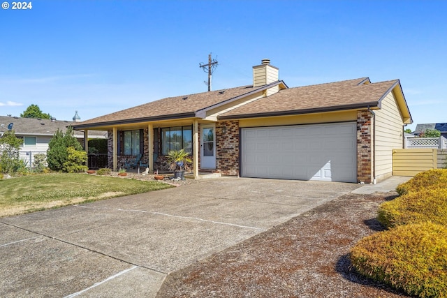 ranch-style home with a front yard and a garage