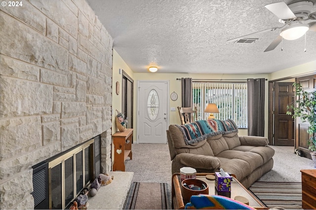 carpeted living room with a fireplace and ceiling fan