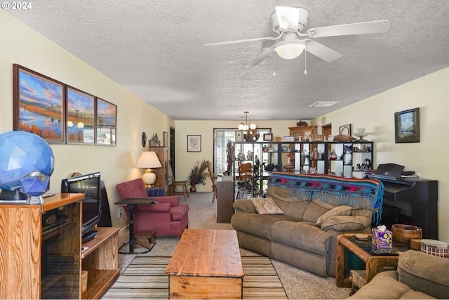 living room with ceiling fan with notable chandelier, light colored carpet, and a textured ceiling