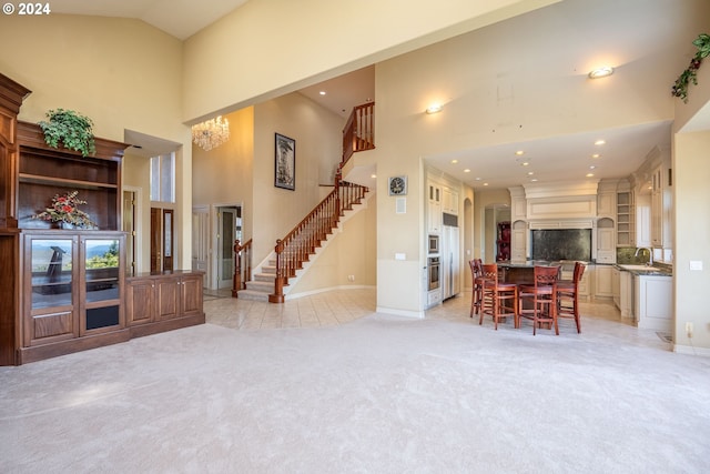 living room with high vaulted ceiling, recessed lighting, light carpet, baseboards, and stairs