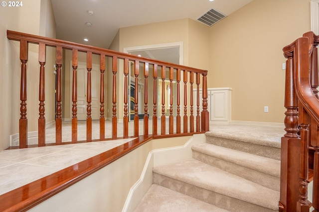 stairs featuring carpet floors, baseboards, and visible vents