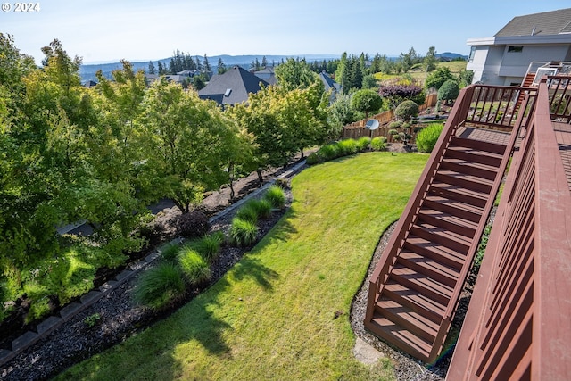 view of yard with stairs and fence