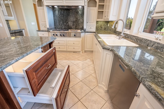 kitchen with light tile patterned floors, a sink, stainless steel gas cooktop, open shelves, and backsplash